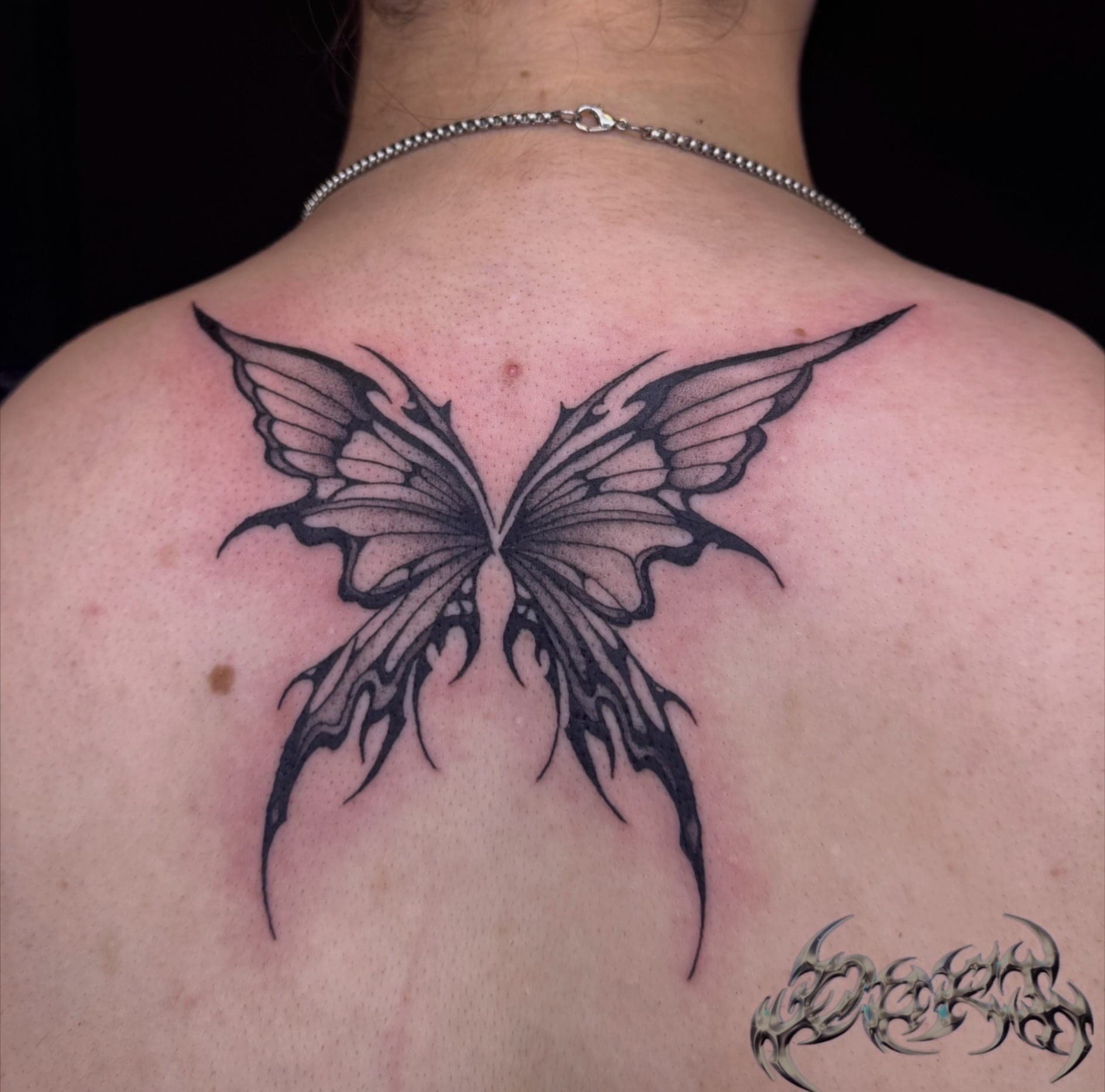 Chrome-effect butterfly tattoo